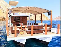 Large catamaran hosting a group party with open bar and dance area